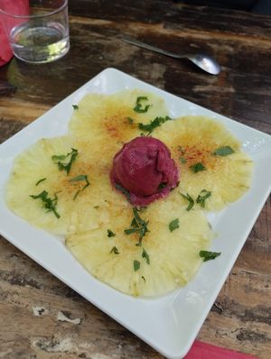 Caramelized Pineapple Carpaccio🍍served with Fresh Mint 🌿 and Black Currant Sorbet 🫐 at Le Cachotier in Carcassonne