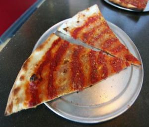 spiral tap: creamy caramelized onion spread, house marinara red sauce and a light dusting of nutritional yeast. at Sizzle Pie - E Burnside in Portland