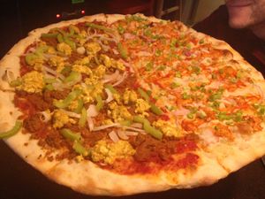 large vegan pizza: half Steve Caballero, half Buffalo 666 at Sizzle Pie - E Burnside in Portland