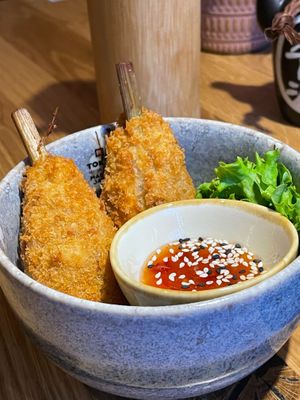 „chicken drumsticks“ on lemongrass bone with chili garlic sauce at Udum in Cologne