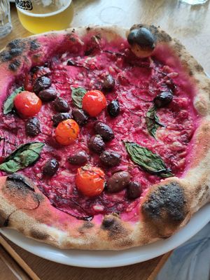 Beetroot base pizza with vegan cheese, olives, tomato, balsamic at Schooners in St Agnes