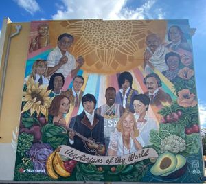 Vegetarians of the World mural outside the restaurant at Mr. Natural - East Cesar in Austin