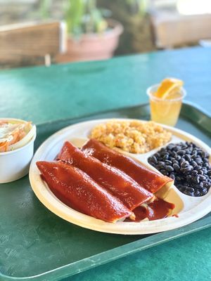 Spinach and mushroom enchilada, beans and rice and a salad with homemade ranch dressing and a wellness shot  at Mr. Natural - East Cesar in Austin