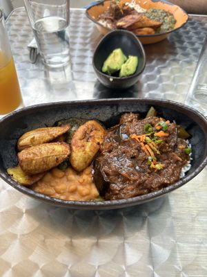Eggplant stew special with coconut rice, side of creamed spinach and white beans, with plantains💜👍  at Baobab Fare in Detroit
