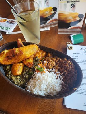 Mboga - Peanut-stewed spinach, half coconut half pilaf rice, stewed yellow beans, and fried plantains at Baobab Fare in Detroit
