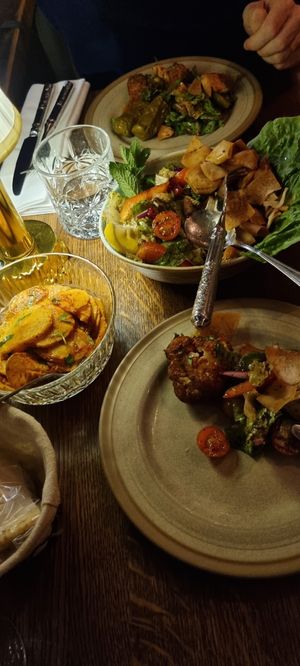 Showing two dishes. One sallad, one potato at Tabbouli - City in Stockholm