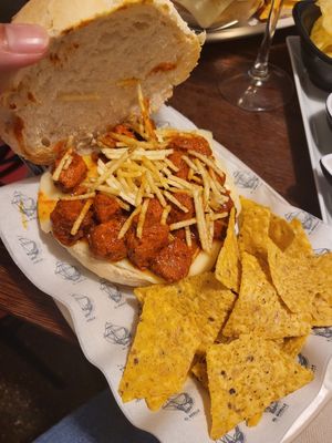 Vegan meatball, vegan cheese, spicy sauce, fried onion sandwhich at Café Bar El Muelle in Santiago De Compostela