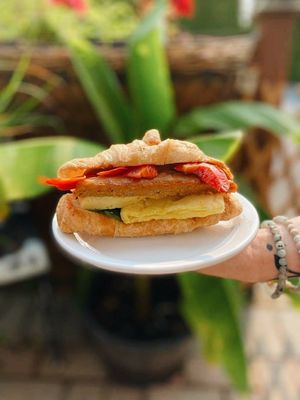 The Vegan Breakfast Croissant, with vegan mayo, Just Egg patty, Beyond Sausage, red pepper and spinach  at The Allenby Coffee Bar in Victoria