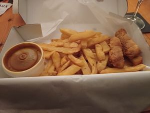 Battered sausage, chips and curry sauce at Sea & Earth in Nottingham