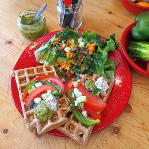 Vegan, gluten-free, savory sweet potato waffle with organic veggies, homemade pesto, and cashew nuts vegan cheese!  at Roots in Aljezur
