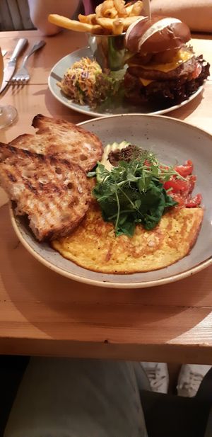 Tortilla de harina de garbanzos con pan tostado, verduras, aguacate y paté de aceitunas negras. at Source in York