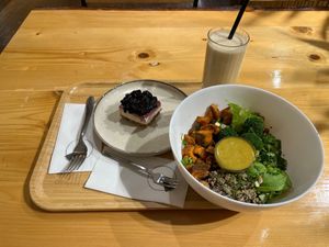 Smoothie, bowl, and vegan dessert on a tray at Crust n Crumb in Pristina