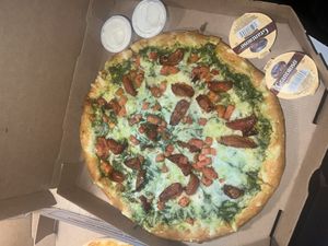 Vegan pesto pizza!! With vegan garlic butter and ranch sides🤍  at Toppers Pizza - Main St in Green Bay