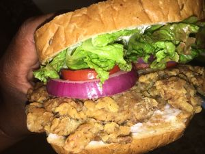 Fried oyster mushroom chickn said with hemp Mayo, house aioli. romaine, roma tomatoes and onions.  at The Alkaline Electric Goddess in Indianapolis