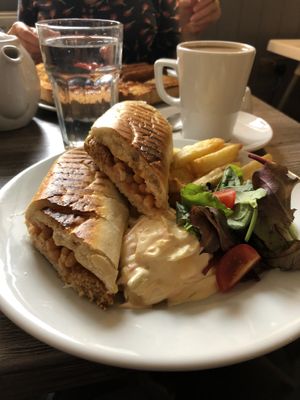 Sausage and bean toastie with vegan coleslaw. Coffee with oat milk   at Fountain Cottage Cafe in Hexham