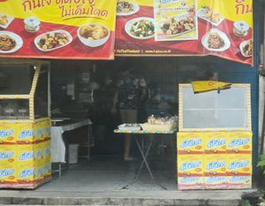 Symbolic Yellow Flags:

In Thailand, stalls and restaurants serving Jai food display yellow flags with red Chinese characters (齋), which means "vegetarian" or "purity." at Shukiat Jaymart - ชูเกียรติเจมาร์ท in Takua Pa