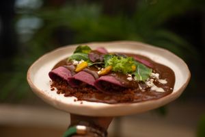 Vegan Mexican enmoladas with Delicious low carb sugar-free mole stuffed with oat chorizo,  vegan cream and cheese, organic lettuce, and golden beets
 at Prana Café in Cancun