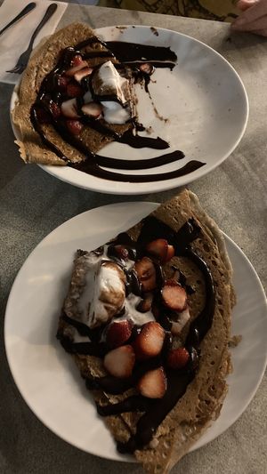 Crêpe - Chocolate sauce, banana, grilled almonds & Vanilla ice cream  ( divided in half)  at Flo's Crêperie in Noosa Heads