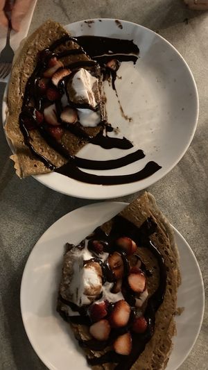Crêpe - Chocolate sauce, banana, grilled almonds & Vegan ice cream 😍 (divided in half)   at Flo's Crêperie in Noosa Heads