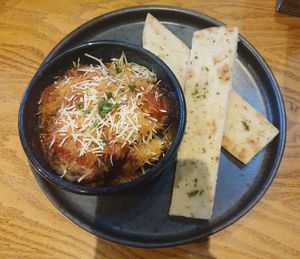 AUBERGINE 'PARMIGIANA' (ve) Roast aubergine in a tomato and herb sauce topped with Prosociano hard cheese. With warm garlic flatbread. at Morning Star in Swinton