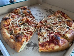 Pizza with onions and mushrooms at Meek's Vegan Pizza in Houston