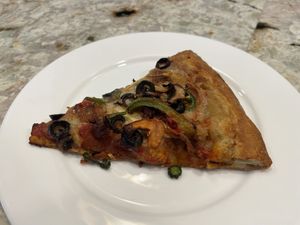 This piece was reheated in the air fryer the next day. It was even better!  at Meek's Vegan Pizza in Houston