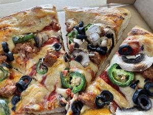 Pizza with beyond sausage, mushroom, and jalapeño.  at Meek's Vegan Pizza in Houston