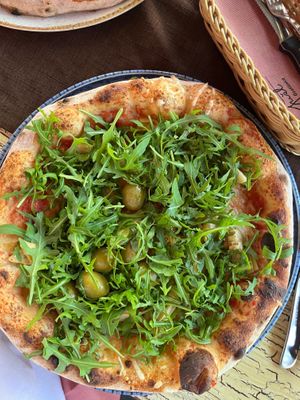 Vegan pizza with added artichokes olives and rocket  at Gostilnica Pizzeria Gust in Izola