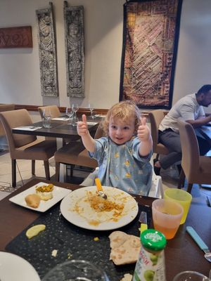 Kids giving the plain curry sauce a thumbs up! at Clay Oven in Albufeira