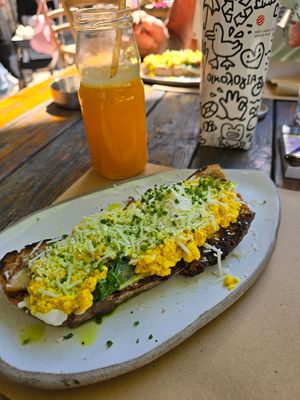 Vegan tofu scramble with mushrooms, spinach vegan cheese on sourdough at Ergon Agora in Thessaloniki