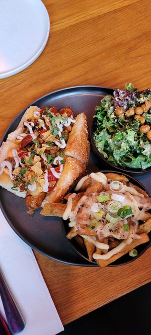 Seitan Hot Dog, side poutine and side caesar salad at Good Dogs Plant Foods in Vancouver