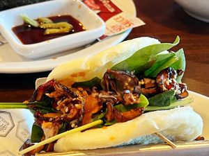 Vegan buns: Steamed buns filled with UMAMI shiitake
mushrooms, sesame seeds, fried onion,
baby mix greens with teriyaki sauce and sesame sauce at Rakkan Ramen in Boulder