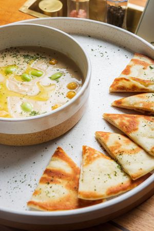 Traditional Hummus - chickpeas, edamame, olive oil, served with pita bread at LEGENDS - Bistro Bar and Sports in Canggu