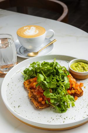 Morning Bruschetta - fresh basil, tomato, red onion, balsamic, olive oil, watercress salad, scoop of guacamole at LEGENDS - Bistro Bar and Sports in Canggu