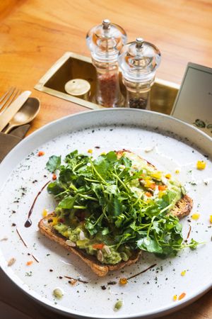Smash Avocado, Greens & Seeds - fresh mixed salad, cashew oil, sunflower swweds, pumpkin seeds, served with baguette or gluten free bread at LEGENDS - Bistro Bar and Sports in Canggu