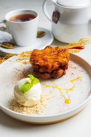 The Pisang Goreng Patisserie, Chef's Creation - fried plantain with battered honey and vanilla dust, served with honey comb, chocolate crumble, and vanilla bean ice cream at LEGENDS - Bistro Bar and Sports in Canggu