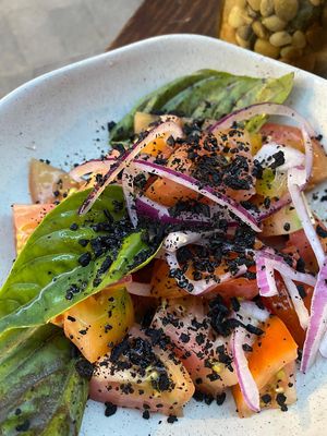 Tomato salad with onions, basil and olive crumble.  at Bar Tomeu in Sitges