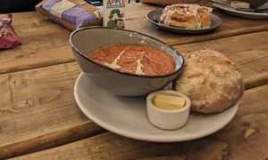 Soup of the day with a cinnamon roll in the background at FRÂN Las in Llanberis