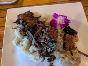 steak on mashed potatoes and gravy at COMMUNITY Kitchen + Taproom in Austin