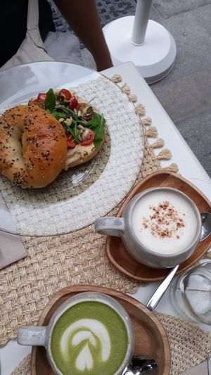 Hummus bagel, chai latte at Biomio Brunch Ecológico in Sevilla