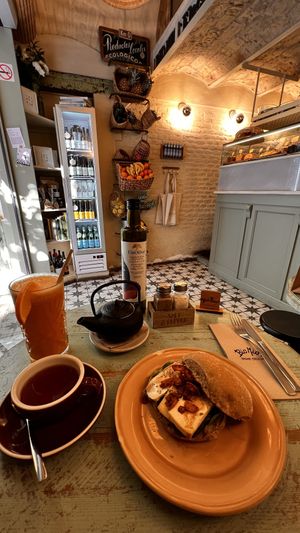 Tofu, avocado cream, spinach, vegan bacon (made from coconut) & sesame seeds. Carrot & ginger juice. Black tea (which turned out to be vanilla, but was nice).  at Biomio Brunch Ecológico in Sevilla