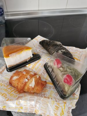 Mango-Cheesecake, Pistachio cake, coconut croissant (Filmes), black croissant with orange flavor at Tentacions in Figueres