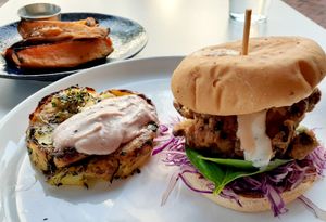 These are Oyster Mushrooms lightly breaded and fried, stacked like a  Burger with a smashed potato herb garlic cake & side of Roasted Sweet Potato Wedges with an herbed dairy free dipping aioli sauce at Christopher's Kitchen in Palm Beach Gardens