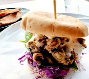 These are Breaded Oyster Mushrooms stacked on all sorts of veggie goodies like a Burger with a smashed potato herb garlic cake & side of Roasted Sweet Potato Wedges with an herbed dairy free dipping aioli sauce at Christopher's Kitchen in Palm Beach Gardens