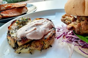 Oyster Mushroom Burger with a smashed potato herb garlic cake & side of Roasted Sweet Potato Wedges with an herbed  dairy free dipping aioli sauce at Christopher's Kitchen in Palm Beach Gardens