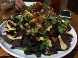 Vegan stacked nachos. Really nice size portion of nachos with vegan cheese, beans, rice, guac, etc. at Christopher's Kitchen in Palm Beach Gardens