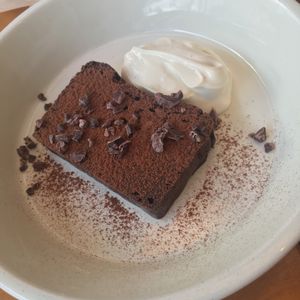 chocolate cake that wasn't much of a 'cake' but had a dense texture with cacao nibs on top and some vanilla bean creme at Cafe Atl in Osaka