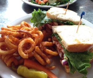 vegan BBQ 'chicken' sandwich with curly fries (front), and vegan Buffalo 'chicken' sandwich with side salad and vegan thousand island dressing. at Downbeat Diner and Lounge in Honolulu