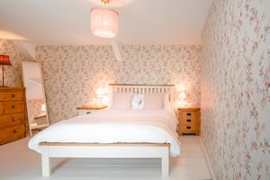 King sized bed in the pet friendly room at The Green Door Vegan B&B - Pet-friendly Room in Llanon