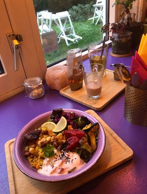 Poha and masala chai in the background  at Little World Kitchen in Utrecht